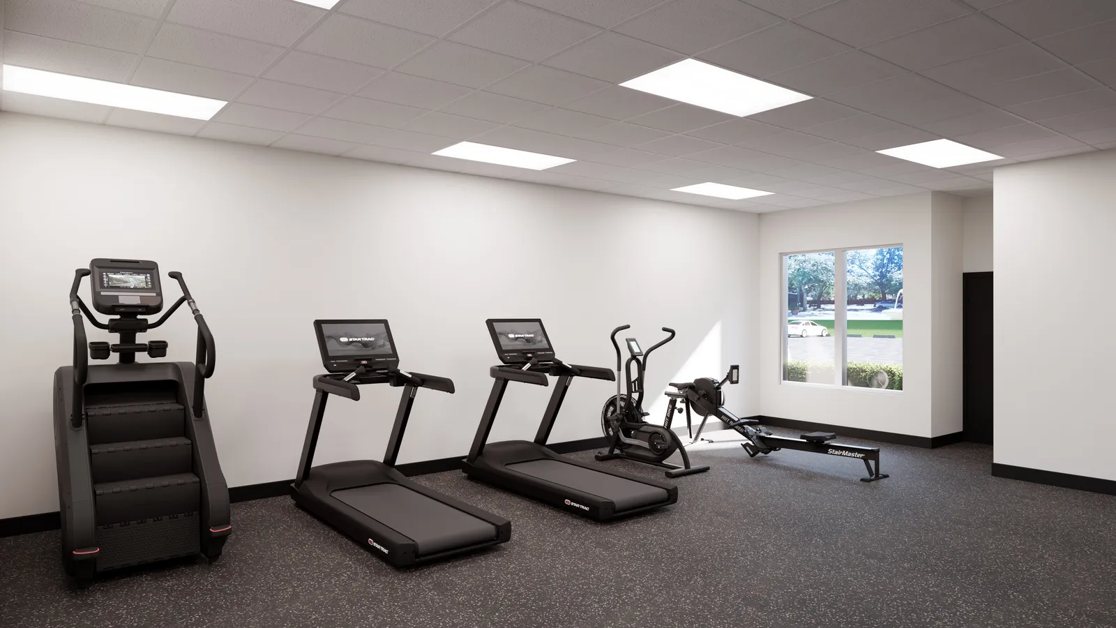 The Valdes Performance cardio zone with treadmills, a stair climber, an air bike, and a rower
