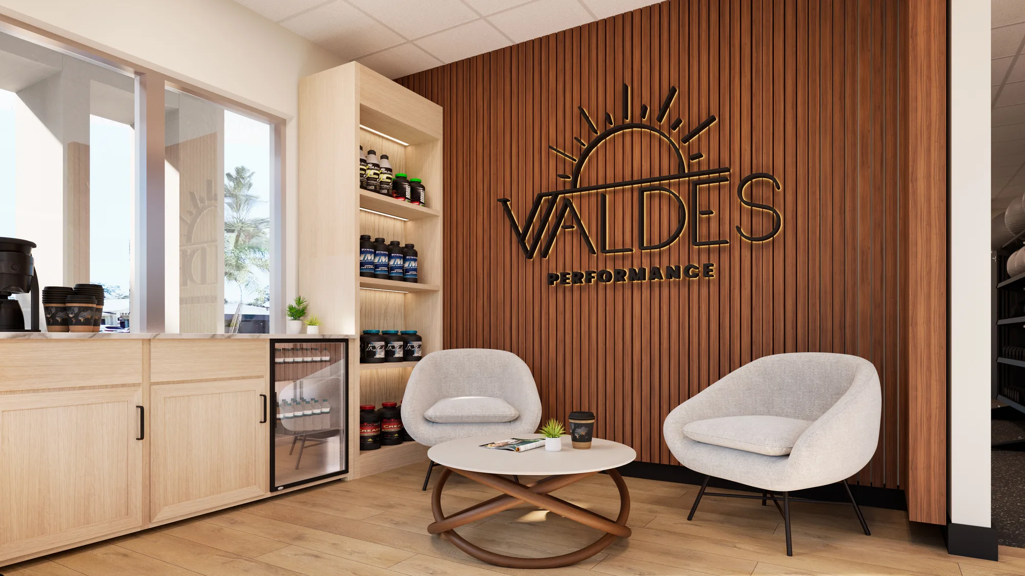The Valdes Performance lounge and fuel bar, with the backlit sun logo on a wood-slat wall, coffee station, and supplement shelves