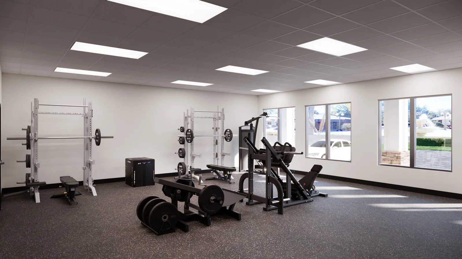 The Valdes Performance power zone with squat racks, a leg press, and loaded barbells